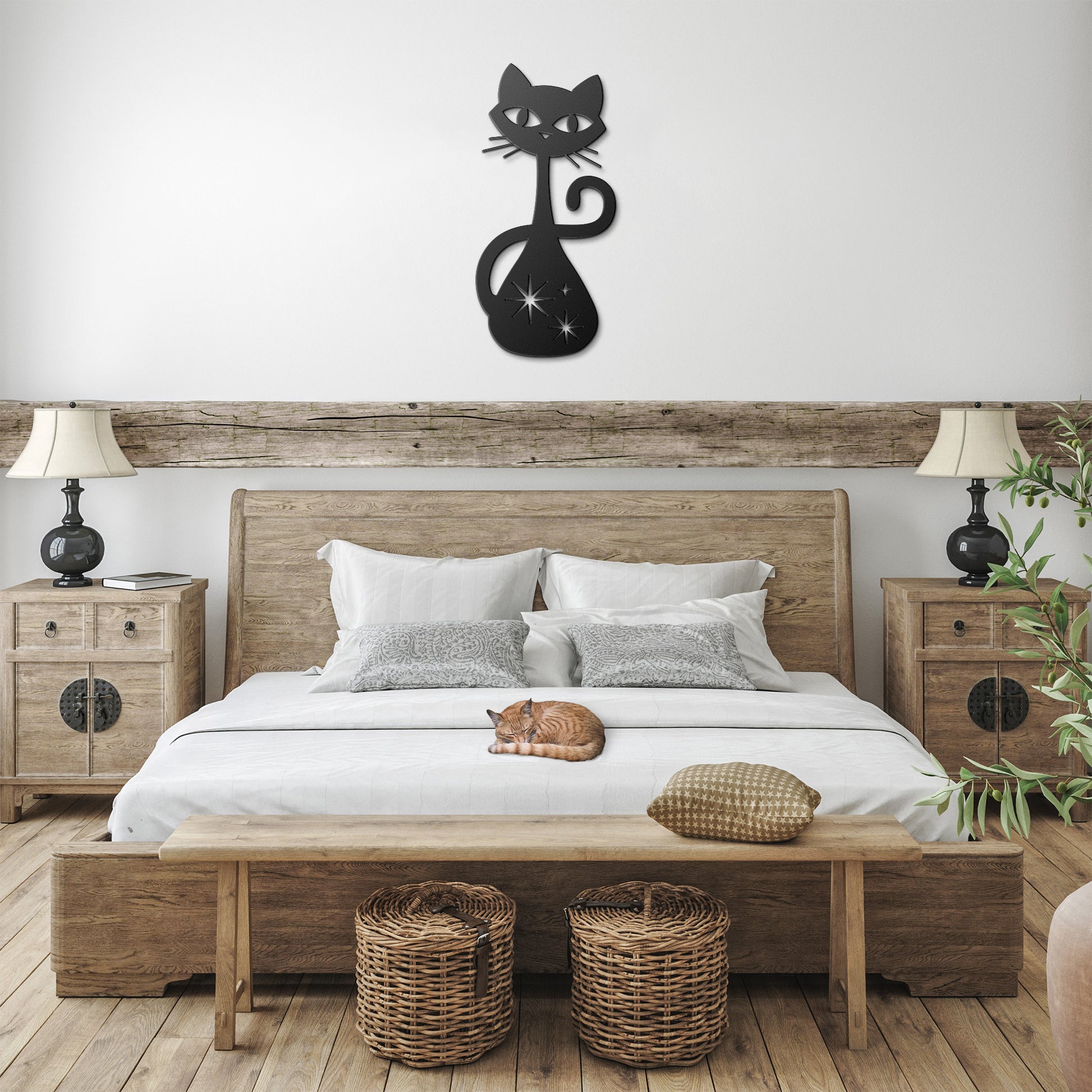 A black atomic cat metal wall art hanging in a farmhouse bedroom.