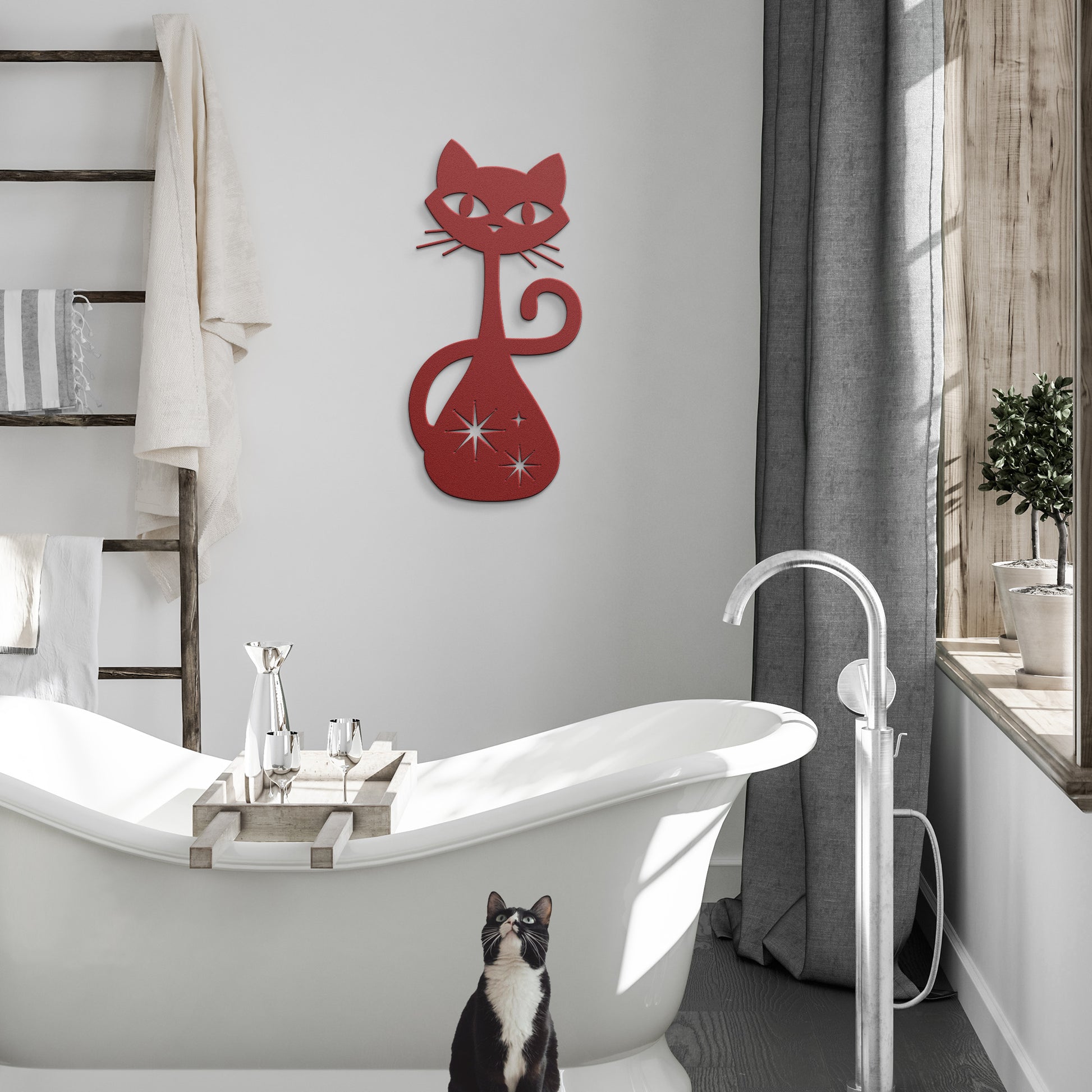A red atomic cat metal wall art on a simple hanging in a modern bathroom.