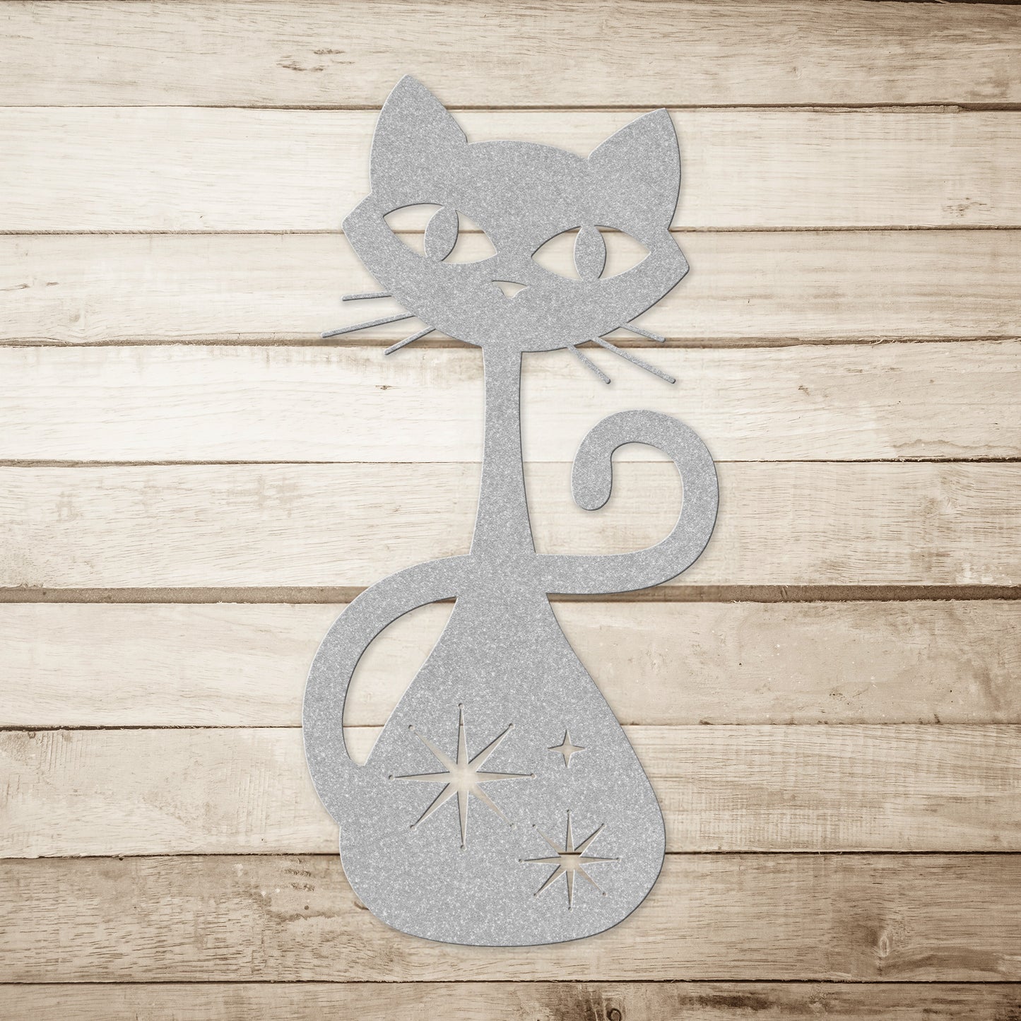 A black atomic cat metal wall art on a simple wood plank background.