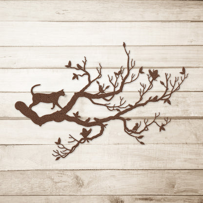 A copper metal wall art decor of a cat stalking birds on a branch on a simple wood background.