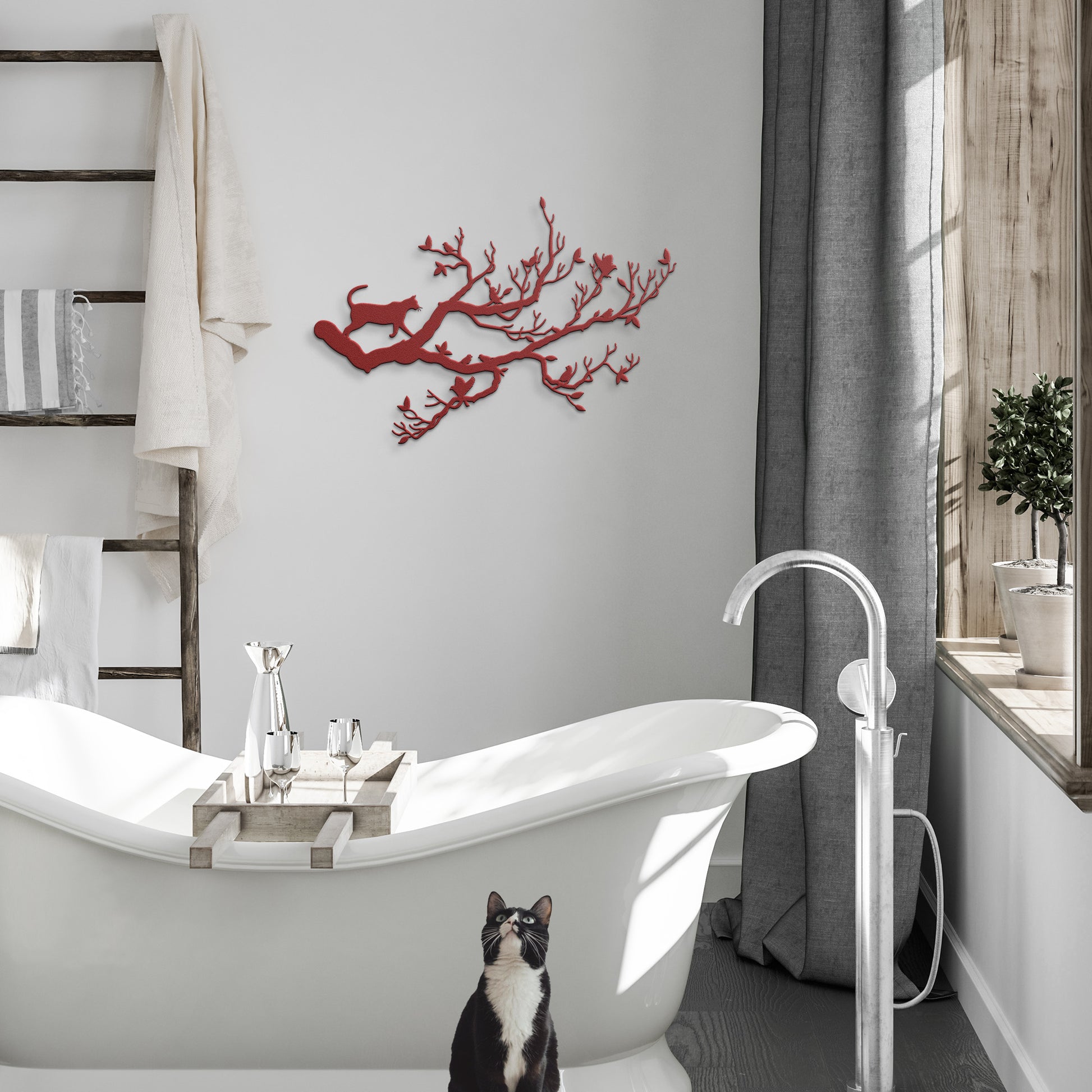 A red metal wall art decor of a cat stalking birds on a branch hanging in a modern bathroom.