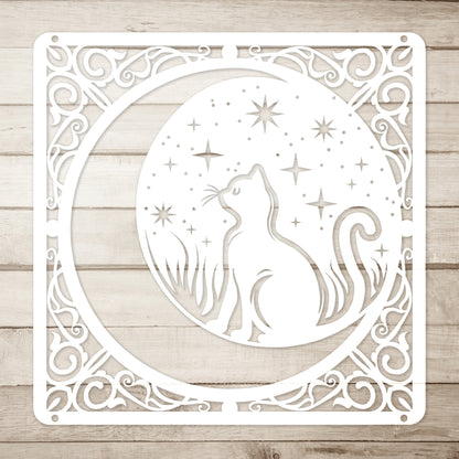 A white home decor metal sign of a cat inside a crescent moon next to a field of stars. All of this is bordered by floral vines. Simple wood background.